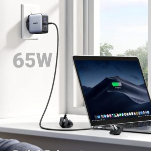 Chargeur Ugreen 65W branché au mur alimentant un MacBook