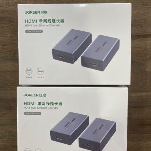 Emballage de l'Extendeur HDMI Ugreen montrant le devant et le derrière, avec des détails sur la portée de 70 m et la connectivité RJ45.